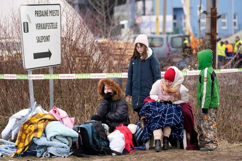 Refugees from Ukraine rest after arriving to the border crossing Vysne Nemecke, Slovakia