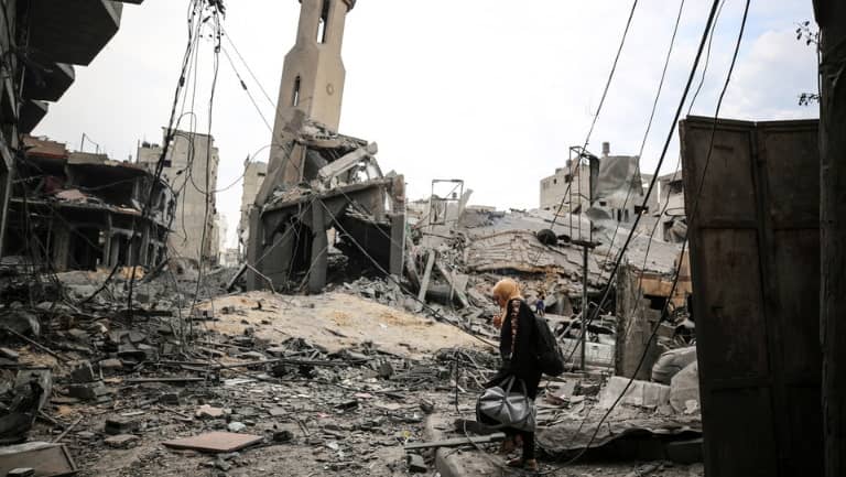 Palestinians inspect a mosque destroyed in Israeli strikes on Gaza City's Shati refugee camp early on October 9, 2023.