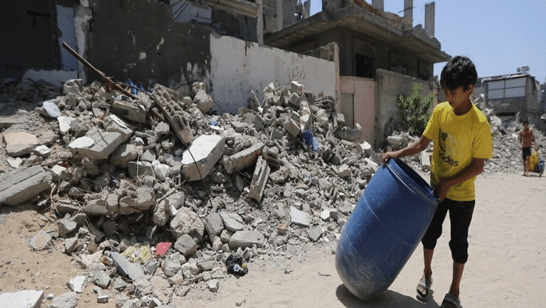 A displaced child holding a water tank in the Middle East.