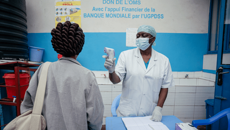 Healthcare worker carrying out Ebola screening for a patient in the Democratic Republic of the Congo.